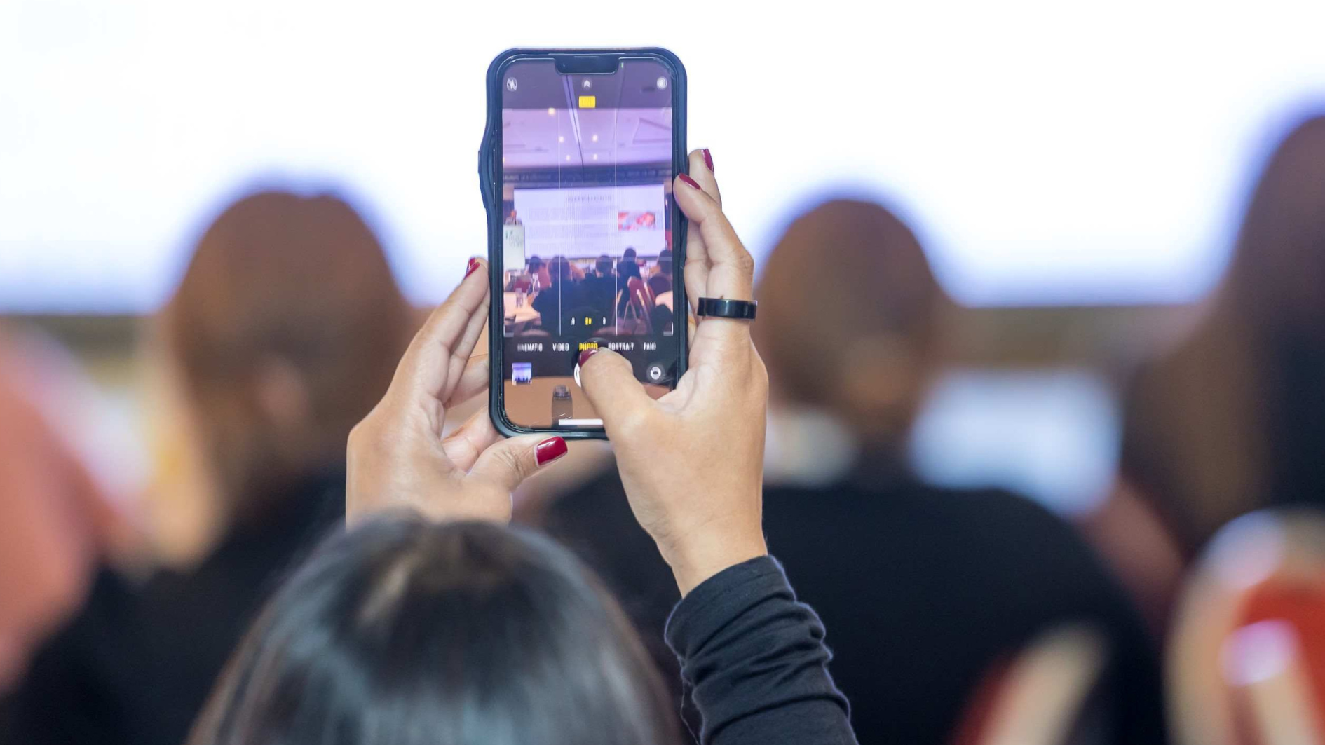 Phone taking photo at conference